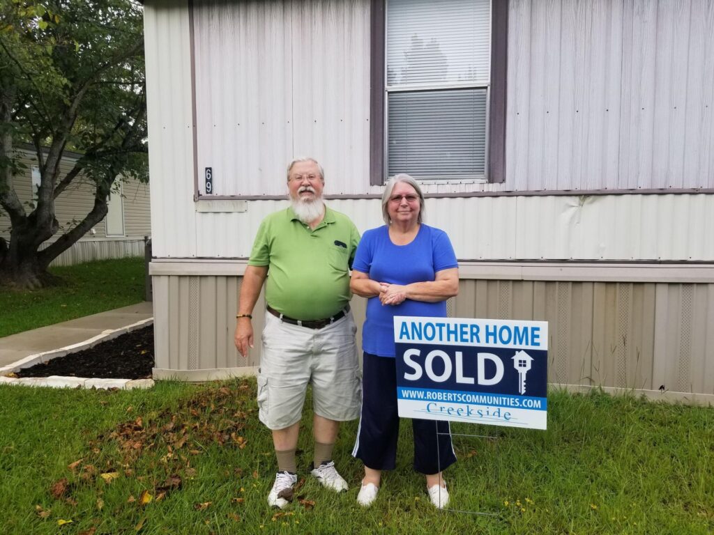 New homeowner with sold sign at Creekside